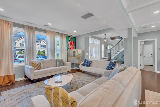 living area featuring wood finished floors, stairs, crown molding, baseboards, and recessed lighting