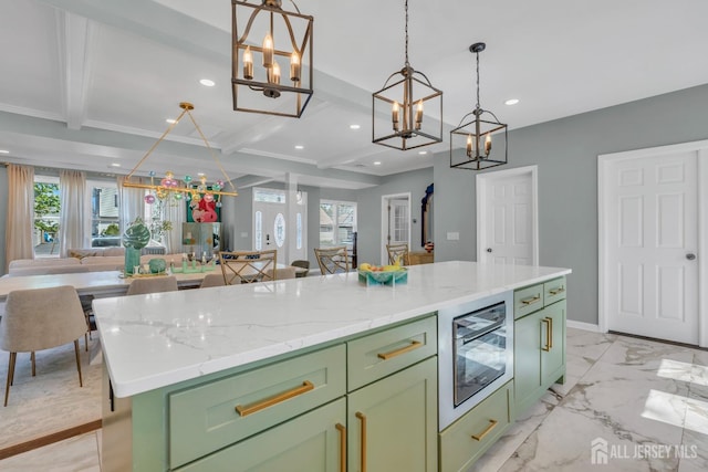 kitchen with green cabinetry, a chandelier, open floor plan, recessed lighting, and beamed ceiling
