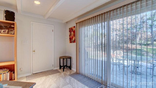 entryway featuring beam ceiling