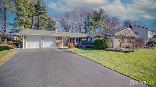 ranch-style house with a front lawn and a garage