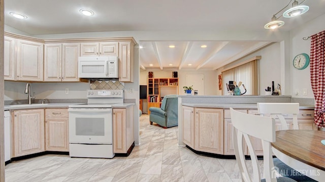 kitchen featuring light brown cabinetry, sink, and white appliances