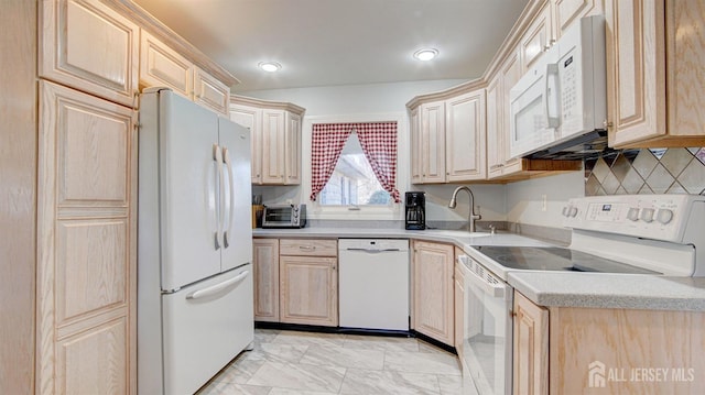 kitchen featuring light brown cabinetry, sink, white appliances, and decorative backsplash