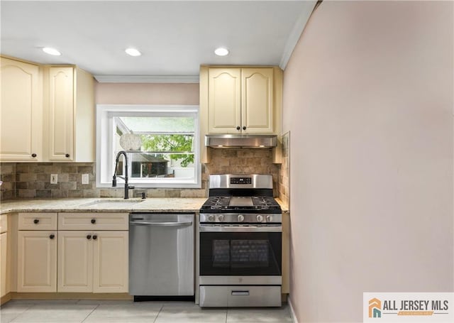 36 George Ave, Old Bridge, NJ 08857 - kitchen featuring stainless steel appliances, a sink, under cabinet range hood, crown molding, and cream cabinets