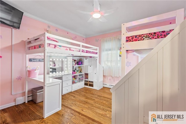 36 George Ave, Old Bridge, NJ 08857 - unfurnished bedroom featuring a baseboard heating unit, wood finished floors, and crown molding