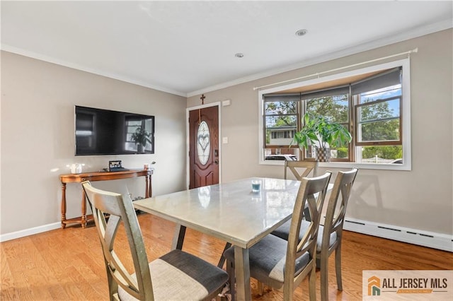 36 George Ave, Old Bridge, NJ 08857 - dining room featuring ornamental molding, a baseboard radiator, light wood finished floors, and baseboards
