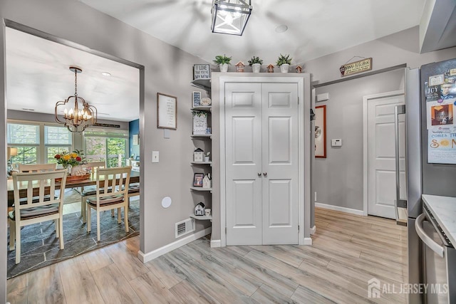 122 Concordia Cir Unit B, Monroe, NJ 08831 - dining space with a chandelier, light wood-type flooring, and baseboards