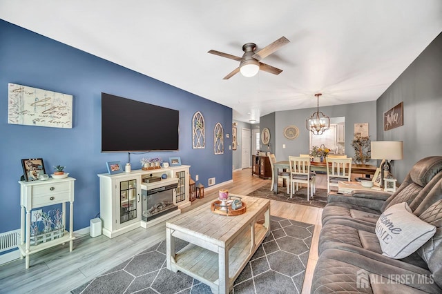 122 Concordia Cir Unit B, Monroe, NJ 08831 - living area with a ceiling fan, wood finished floors, a chandelier, and baseboards