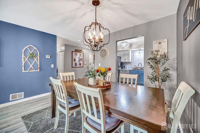 122 Concordia Cir Unit B, Monroe, NJ 08831 - dining room featuring a chandelier, wood finished floors, and baseboards