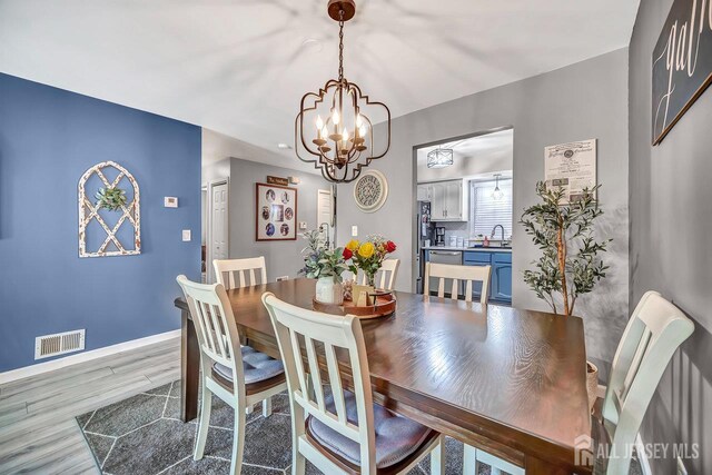 122 Concordia Cir Unit B, Monroe, NJ 08831 - dining area featuring a chandelier and wood finished floors