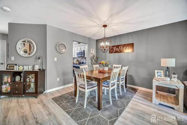 122 Concordia Cir Unit B, Monroe, NJ 08831 - dining area featuring a chandelier, wood finished floors, and baseboards