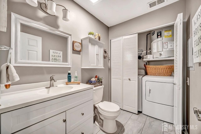 122 Concordia Cir Unit B, Monroe, NJ 08831 - bathroom featuring a closet, vanity, toilet, marble finish floors, and water heater