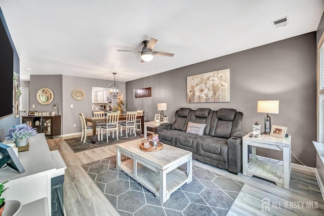 122 Concordia Cir Unit B, Monroe, NJ 08831 - living area with ceiling fan, a chandelier, wood finished floors, and baseboards