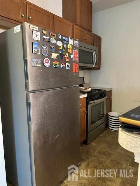 533 E Celebration Way S, Plainfield, NJ 07080 - kitchen with appliances with stainless steel finishes, brown cabinetry, and light countertops