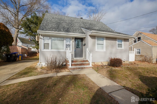 bungalow-style home featuring a front yard