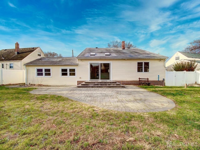 back of property featuring a patio area and a yard