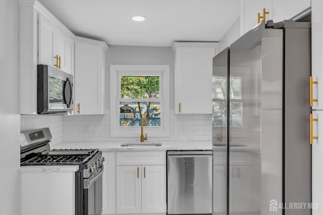 97 Battle Hill Ave, Springfield, NJ 07081 - kitchen with stainless steel appliances, white cabinetry, decorative backsplash, and recessed lighting