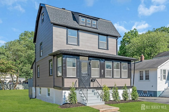 97 Battle Hill Ave, Springfield, NJ 07081 - view of front of house with a shingled roof, a front lawn, and a sunroom