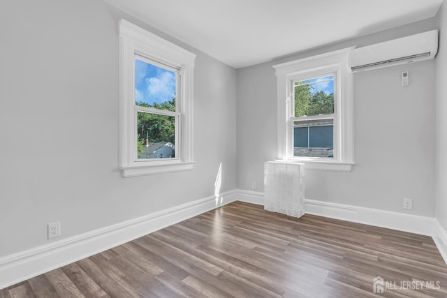 97 Battle Hill Ave, Springfield, NJ 07081 - spare room with a wall mounted air conditioner and wood finished floors