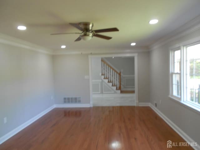 4 Harvey Rd, South Brunswick, NJ 08852 - spare room featuring crown molding, stairs, a ceiling fan, recessed lighting, and wood finished floors