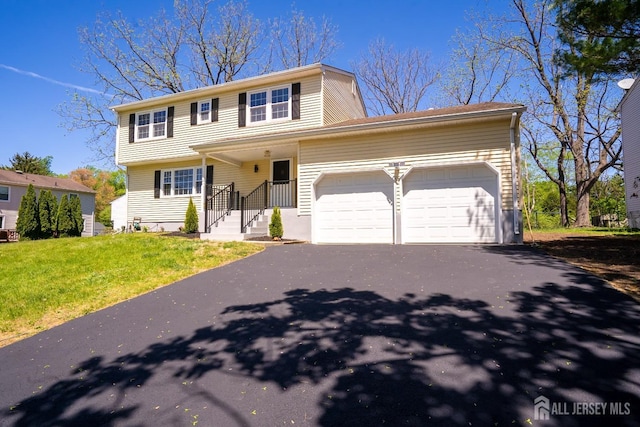4 Harvey Rd, South Brunswick, NJ 08852 - view of front of house featuring a garage, driveway, and a front lawn