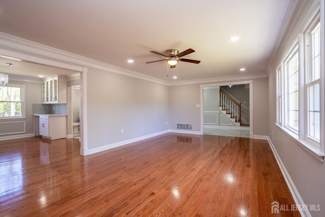 4 Harvey Rd, South Brunswick, NJ 08852 - unfurnished living room with stairway, ceiling fan, wood finished floors, crown molding, and baseboards