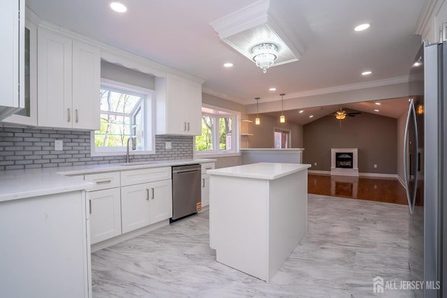 4 Harvey Rd, South Brunswick, NJ 08852 - kitchen featuring appliances with stainless steel finishes, a sink, backsplash, open floor plan, and white cabinetry