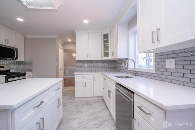 4 Harvey Rd, South Brunswick, NJ 08852 - kitchen featuring stainless steel appliances, a sink, backsplash, white cabinetry, and light marble finish flooring