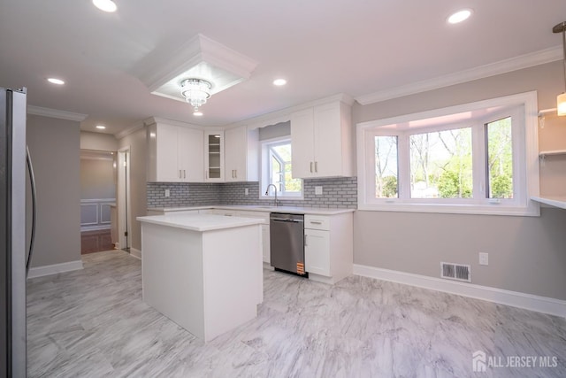 4 Harvey Rd, South Brunswick, NJ 08852 - kitchen with appliances with stainless steel finishes, ornamental molding, white cabinetry, light countertops, and tasteful backsplash