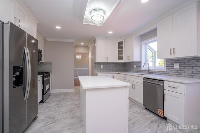 4 Harvey Rd, South Brunswick, NJ 08852 - kitchen featuring appliances with stainless steel finishes, a sink, light marble finish flooring, backsplash, and light countertops