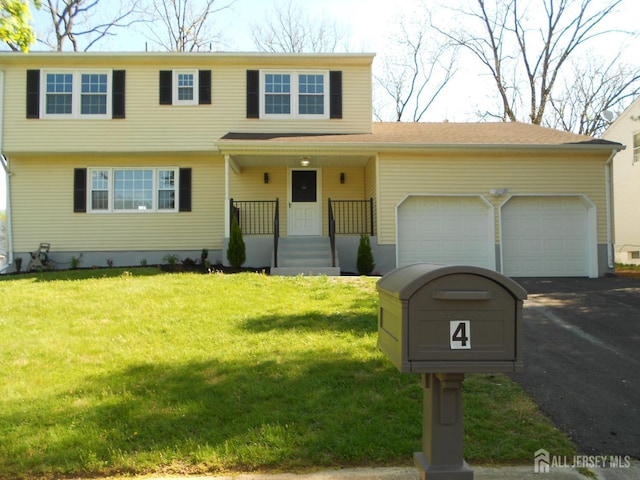 4 Harvey Rd, South Brunswick, NJ 08852 - view of front facade with a garage, asphalt driveway, and a front lawn
