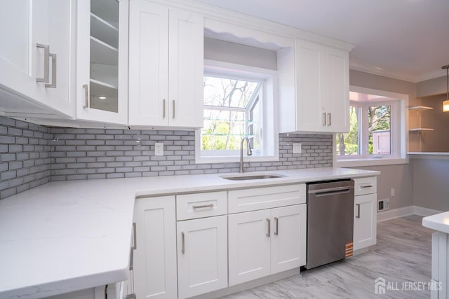 4 Harvey Rd, South Brunswick, NJ 08852 - kitchen with dishwasher, a sink, white cabinets, decorative backsplash, and ornamental molding