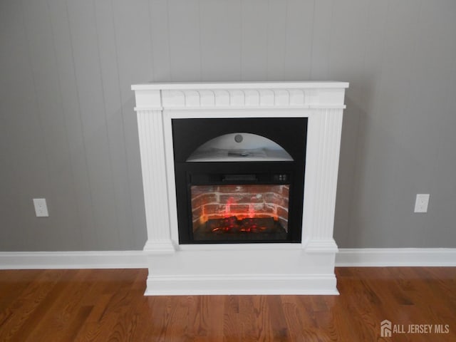 4 Harvey Rd, South Brunswick, NJ 08852 - detailed view of a fireplace, wood finished floors, and baseboards