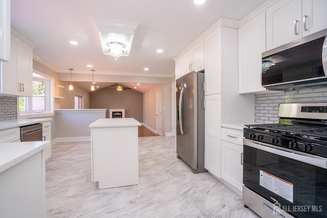 4 Harvey Rd, South Brunswick, NJ 08852 - kitchen featuring appliances with stainless steel finishes, decorative backsplash, white cabinets, ornamental molding, and a ceiling fan
