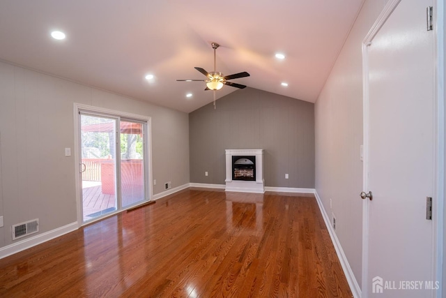 4 Harvey Rd, South Brunswick, NJ 08852 - unfurnished living room featuring wood finished floors, ceiling fan, a fireplace with raised hearth, vaulted ceiling, and recessed lighting