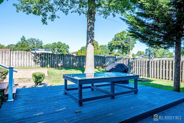 wooden deck with a yard