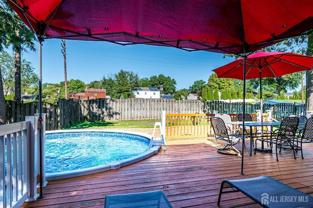 view of swimming pool featuring a wooden deck