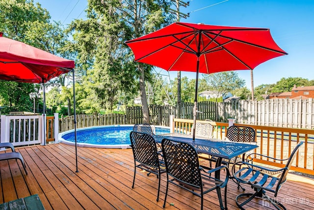 wooden terrace featuring a fenced in pool