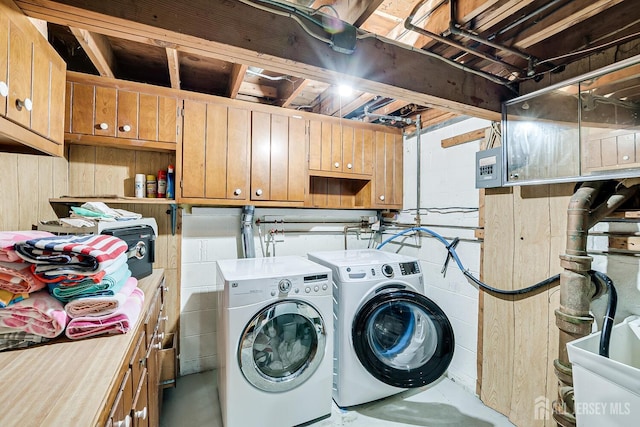 laundry area with independent washer and dryer and sink