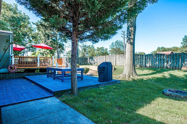 view of yard featuring an outdoor fire pit and a wooden deck