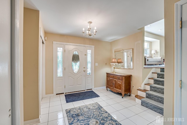 entrance foyer featuring light tile patterned floors and an inviting chandelier