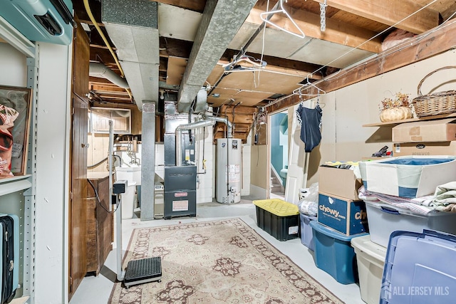 basement featuring heating unit and water heater