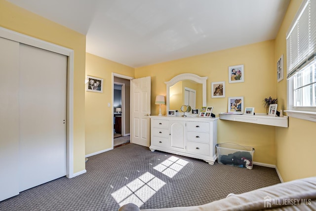 bedroom featuring a closet and dark carpet