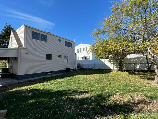 back of property featuring central AC