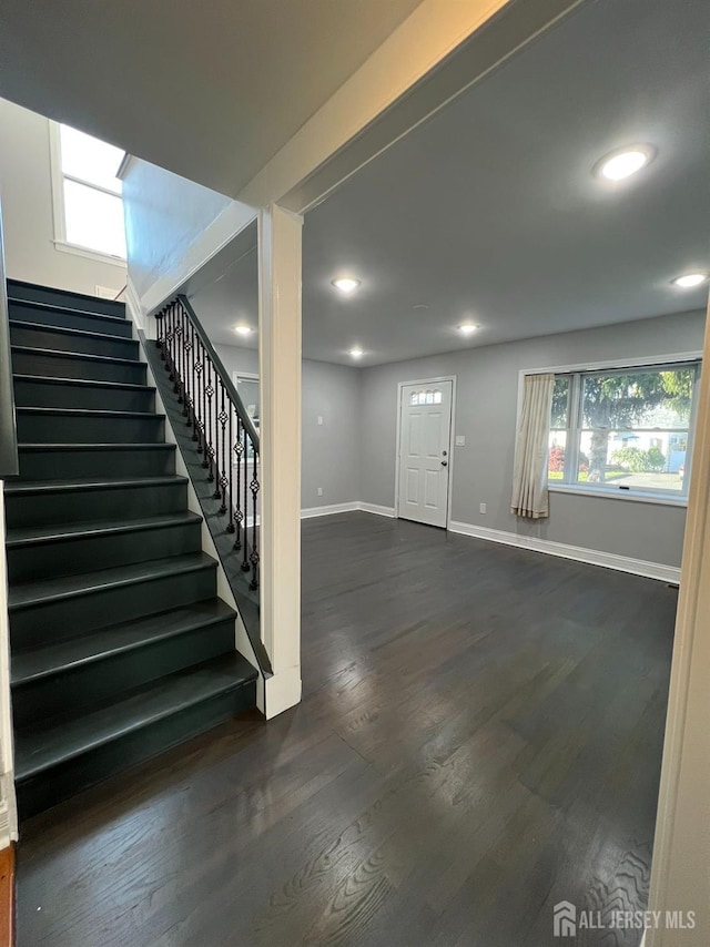 foyer featuring stairway, baseboards, dark wood finished floors, and recessed lighting