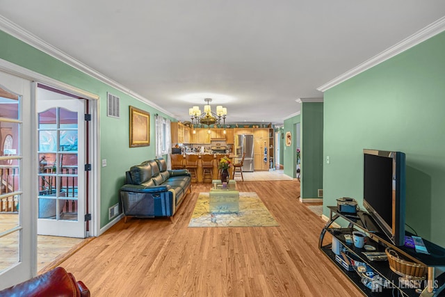 34 Brookside Ave, Old Bridge, NJ 08857 - living room with ornamental molding, a chandelier, light wood-style flooring, and baseboards