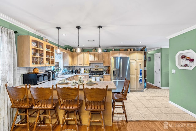 34 Brookside Ave, Old Bridge, NJ 08857 - kitchen with appliances with stainless steel finishes, baseboards, crown molding, glass insert cabinets, and backsplash