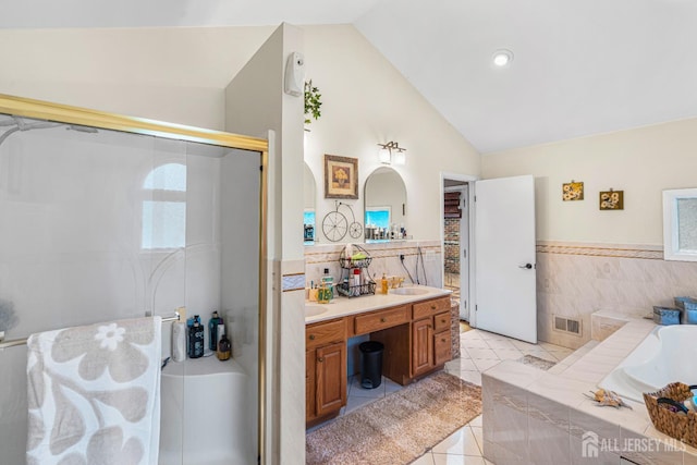 34 Brookside Ave, Old Bridge, NJ 08857 - bathroom featuring lofted ceiling, double vanity, tile walls, a stall shower, and a bath
