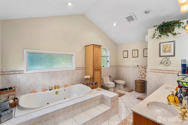 34 Brookside Ave, Old Bridge, NJ 08857 - bathroom featuring a bidet, wainscoting, a jetted tub, lofted ceiling, and double vanity