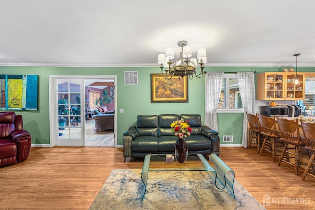 34 Brookside Ave, Old Bridge, NJ 08857 - living room featuring ornamental molding, baseboards, a chandelier, wood finished floors, and french doors