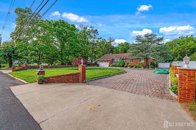 34 Brookside Ave, Old Bridge, NJ 08857 - ranch-style home with decorative driveway, a front lawn, an attached garage, view of scattered trees, and a chimney